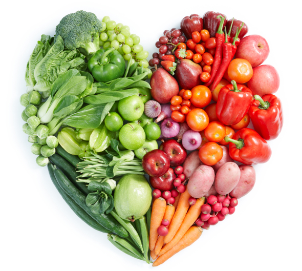 A heart shaped arrangement of fruits and vegetables on a white background.